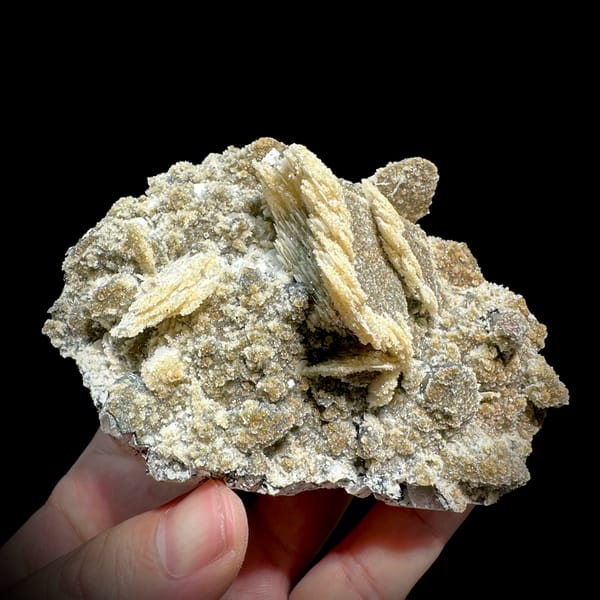 Tan calcite blades with zeolite and quartz on feldspar from Yunxiao, Fujian, China, close-up of the crystal faces