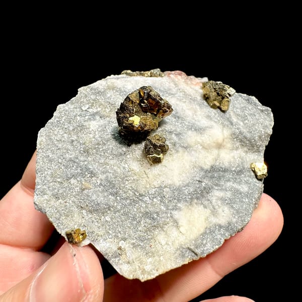 Brassy pyrite crystal clusters on pale sugary plate from Fujian, China, top view