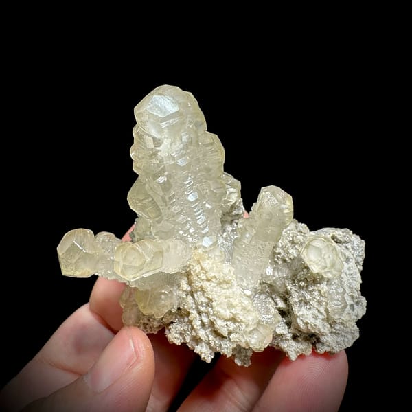 Cream calcite cross with stacked crystals over dolomite from Guizhou, China, second angle