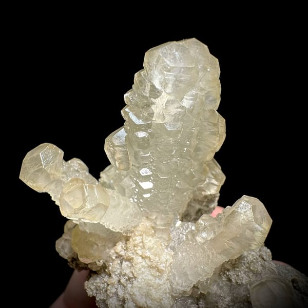 Cream calcite cross with stacked crystals over dolomite from Guizhou, China, reverse side