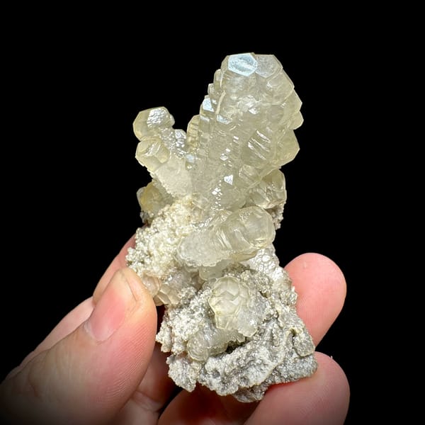 Cream calcite cross with stacked crystals over dolomite from Guizhou, China, top view