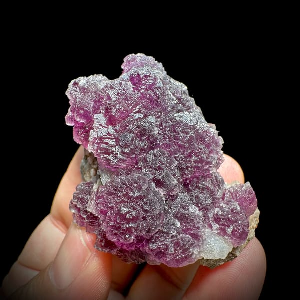 Raspberry-purple stepped fluorite crystals from Zhejiang, China, reverse side