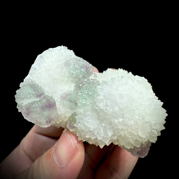 Purple-green fluorite balls beside white quartz needles from Fujian, China, top view