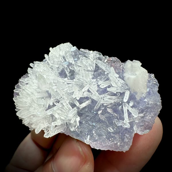 Clear quartz needles over lavender-blue fluorite from Fujian, China, close-up of the crystal faces