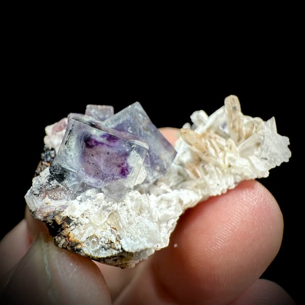 Phantom-zoned blue-purple fluorite cube on quartz from Inner Mongolia, China, close-up of the crystal faces