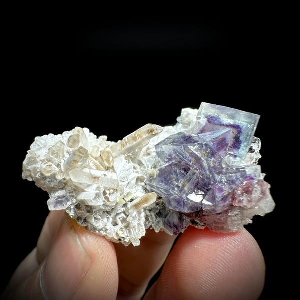 Phantom-zoned blue-purple fluorite cube on quartz from Inner Mongolia, China, detail of the matrix contact