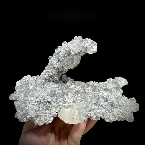 Branching frosted transparent calcite cluster from Fujian, China, detail of the matrix contact