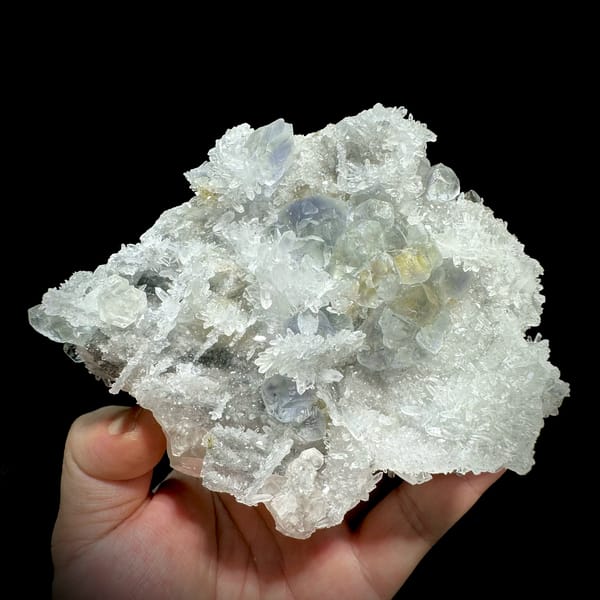 Blue-cored green fluorite among sparkling quartz and calcite from Fujian, China, close-up of the crystal faces