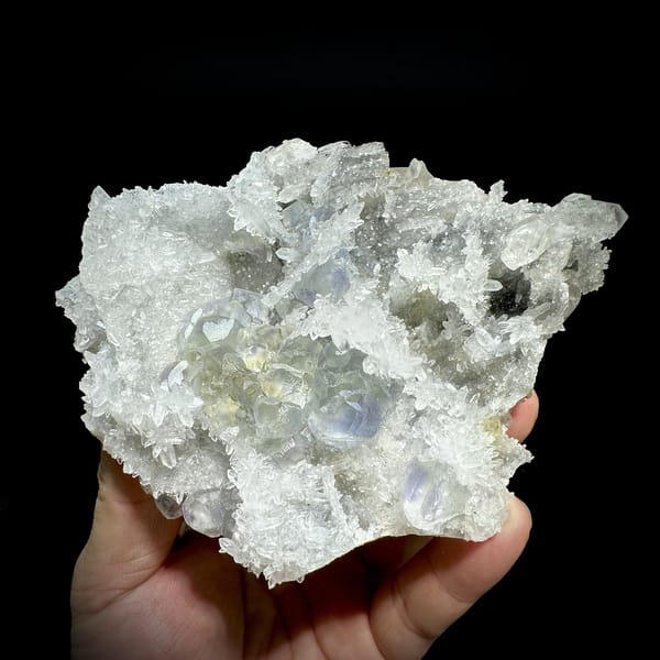 Blue-cored green fluorite among sparkling quartz and calcite from Fujian, China, detail of the matrix contact