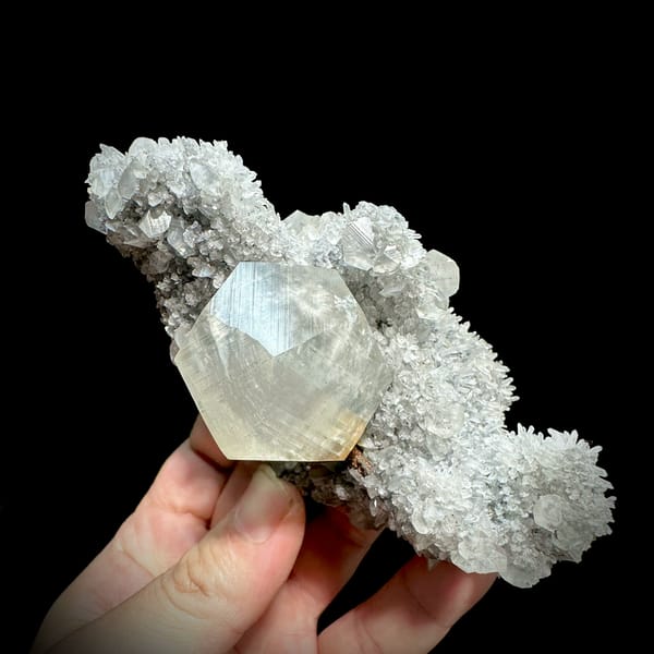 Large star calcite crystal on quartz needles with pyrite from Fujian, China, close-up of the crystal faces