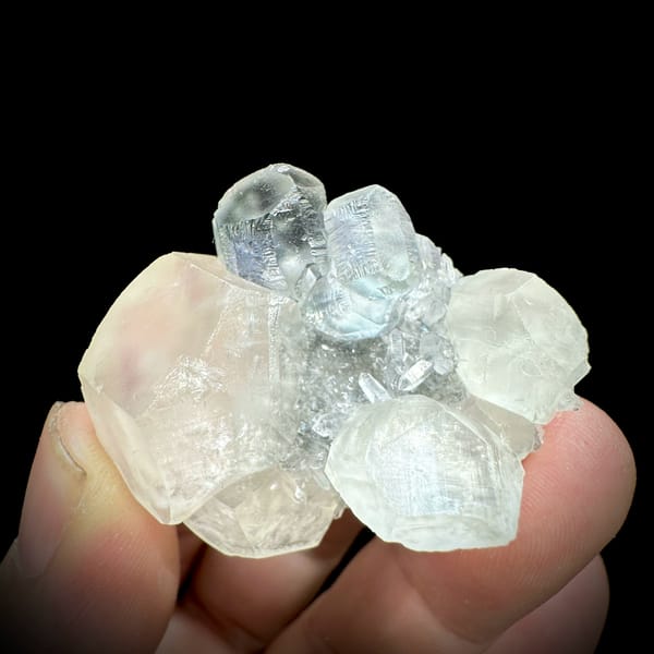 Glassy green fluorite with blue cores and milky calcite from Fujian, China, close-up of the crystal faces