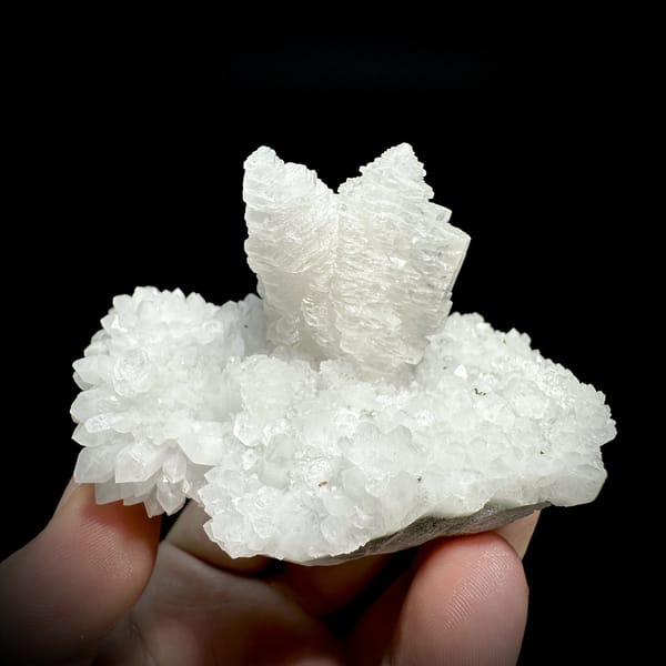 Stacked pagoda calcite tower on white quartz from Guangdong, China, detail of the matrix contact