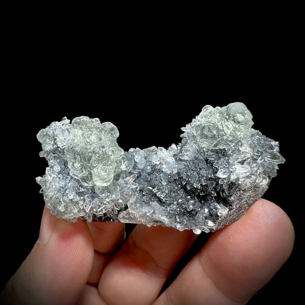Pale green stepped fluorite on dark quartz druse from Fujian, China, second angle