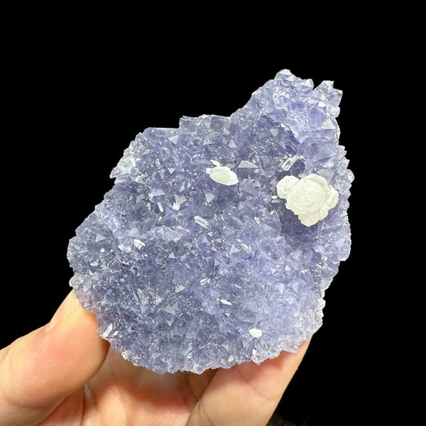 Lavender-blue fluorite plate with white calcite rosette from Fujian, China, close-up of the crystal faces