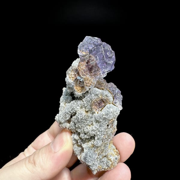 Lavender fluorite cubes on tall grey quartz stalk from Fujian, China, detail of the matrix contact