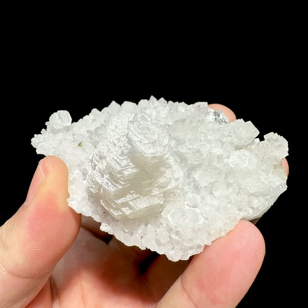 White pagoda calcite tower on quartz druse from Guangdong, China, reverse side