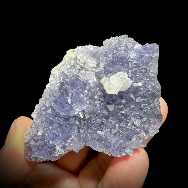 Lavender fluorite plate with white calcite rosette from Fujian, China, close-up of the crystal faces