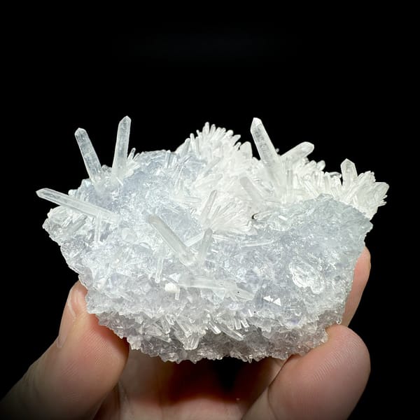 Clear quartz needles over pale blue fluorite from Fujian, China, detail of the matrix contact