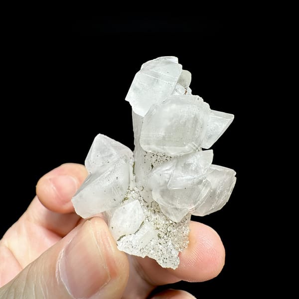 Stacked translucent calcite rhombs with pyrite from Fujian, China, detail of the matrix contact