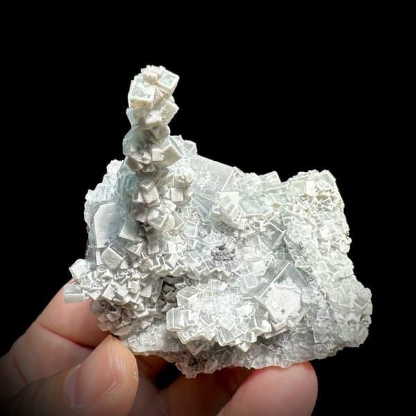 Sketch-patterned fluorite pillar of stacked cubes from Fujian, China, reverse side