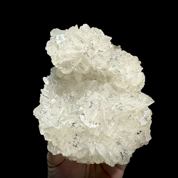 Rounded plate of flower-form calcite with limonite from Fujian, China, close-up of the crystal faces