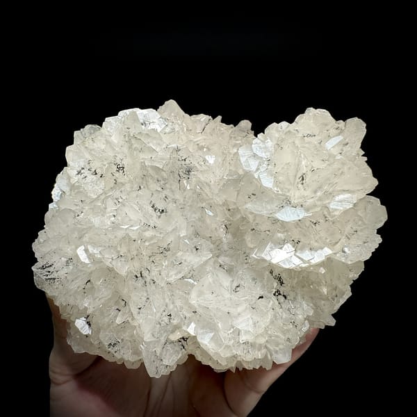 Rounded plate of flower-form calcite with limonite from Fujian, China, detail of the matrix contact