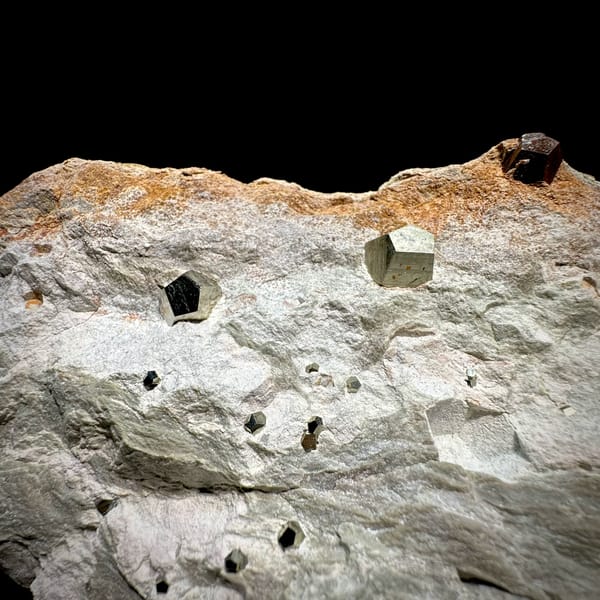Small pyritohedral pyrite crystals on pale matrix block from Guangxi, China, second angle