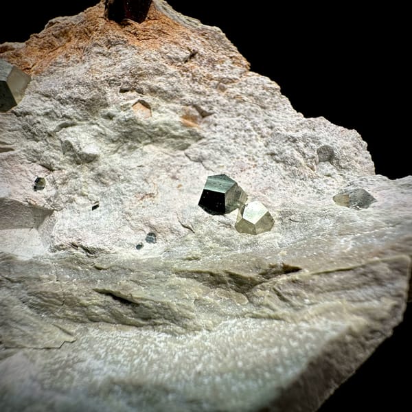 Small pyritohedral pyrite crystals on pale matrix block from Guangxi, China, reverse side