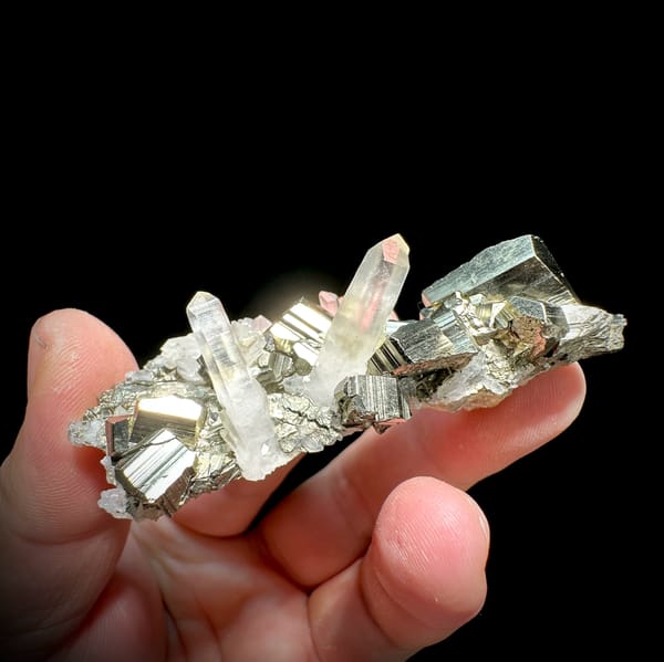 Striated pyrite cube on clear quartz and calcite from Indonesia, top view