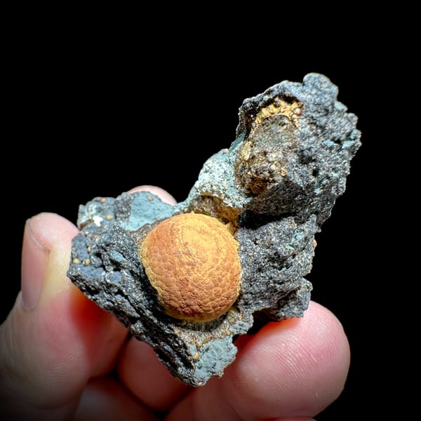 Egg-yolk orange calcite ball in grey pocket from Fujian, China, reverse side