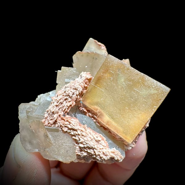 Honey-yellow fluorite cube on pink baryte and calcite from Beijing, China, reverse side