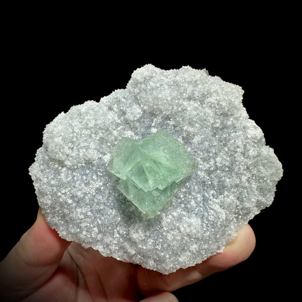 Mint-green fluorite cube on sparkling pyrite-dusted quartz from Fujian, China, close-up of the crystal faces