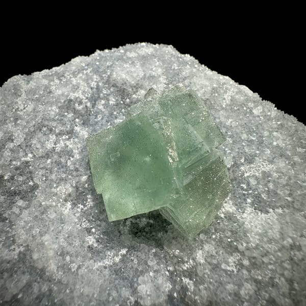 Mint-green fluorite cube on sparkling pyrite-dusted quartz from Fujian, China, top view