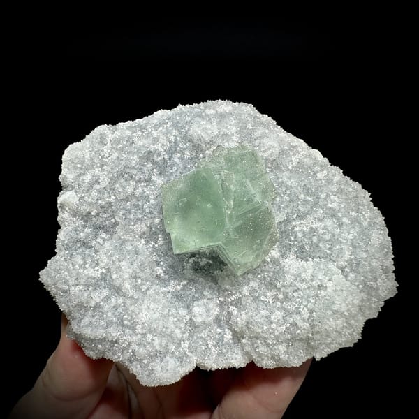 Mint-green fluorite cube on sparkling pyrite-dusted quartz from Fujian, China, detail of the matrix contact
