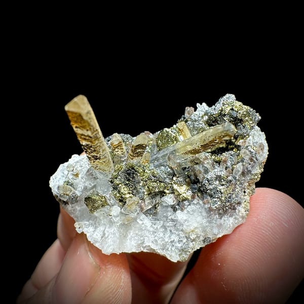 Clear quartz points with chalcopyrite and freibergite from Inner Mongolia, China, close-up of the crystal faces