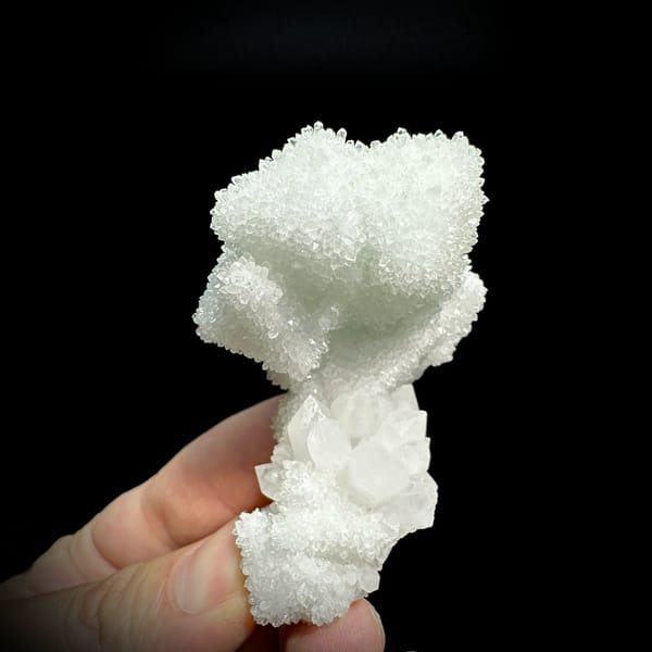 Mint-white sugar-frosted fluorite octahedron group from Guangdong, China, held in hand