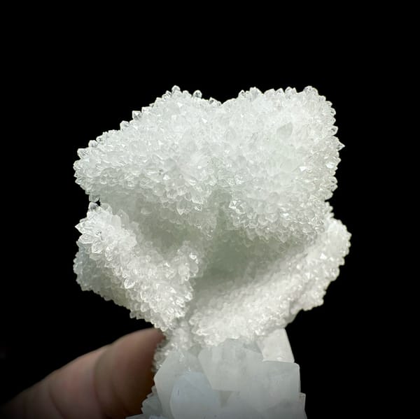 Mint-white sugar-frosted fluorite octahedron group from Guangdong, China, close-up of the crystal faces