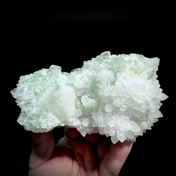Stepped green fluorite octahedra in white quartz from Guangdong, China, held in hand