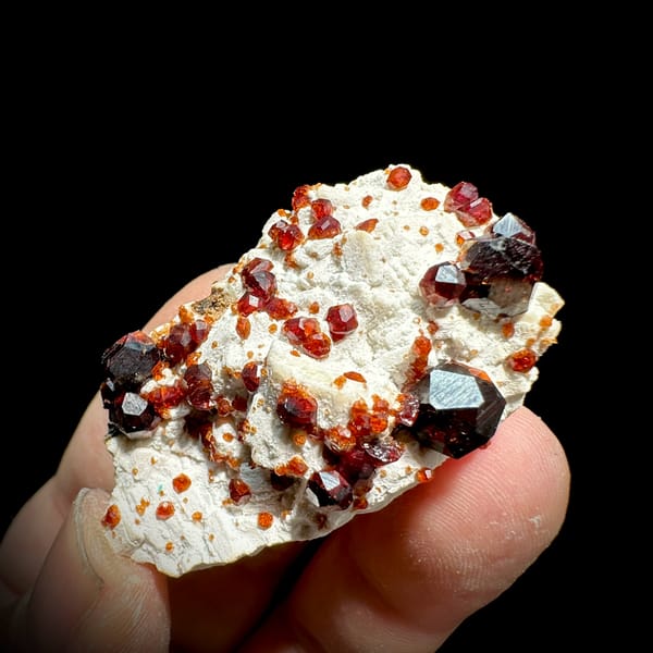 Wine-red garnet crystals on cream feldspar from Yunxiao, Fujian, China, reverse side