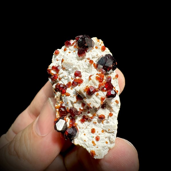 Wine-red garnet crystals on cream feldspar from Yunxiao, Fujian, China, top view