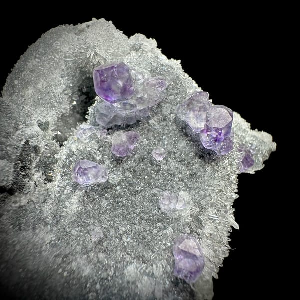 Purple fluorite octahedra on grey quartz mound from Fujian, China, reverse side