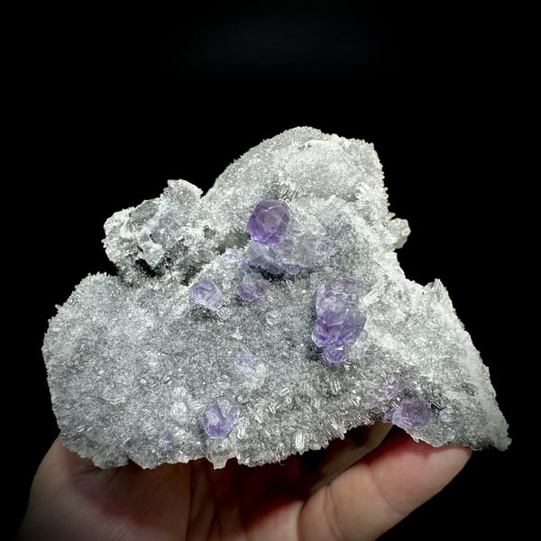 Purple fluorite octahedra on grey quartz mound from Fujian, China, detail of the matrix contact