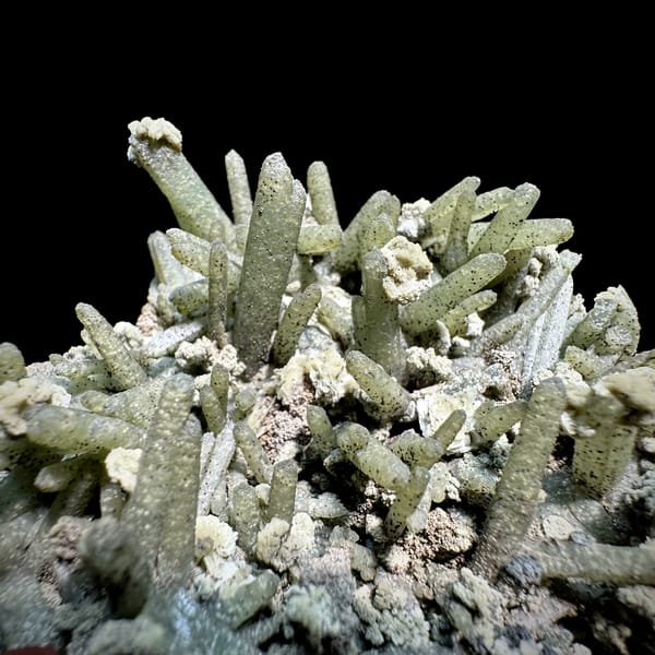 Green chlorite-coated quartz prisms with calcite and goethite from Inner Mongolia, China, close-up of the crystal faces