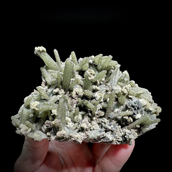 Green chlorite-coated quartz prisms with calcite and goethite from Inner Mongolia, China, detail of the matrix contact