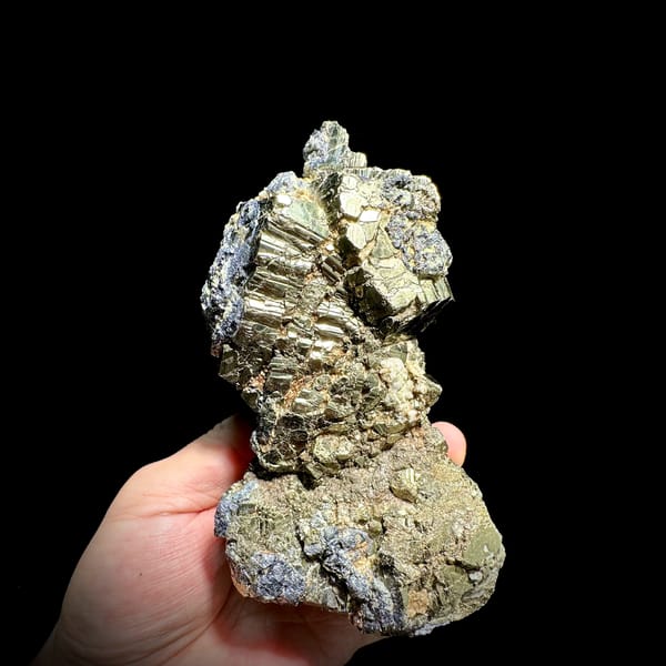 Gourd-shaped block of striated pyrite with galena from Hunan, China, close-up of the crystal faces