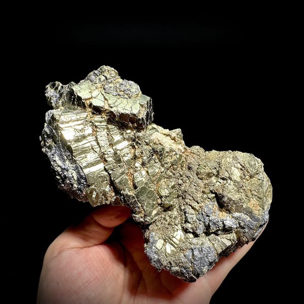 Gourd-shaped block of striated pyrite with galena from Hunan, China, detail of the matrix contact