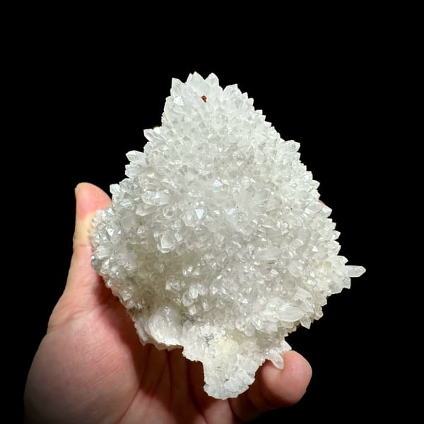 Hollow-shell quartz cluster covered in white points from Fujian, China, close-up of the crystal faces