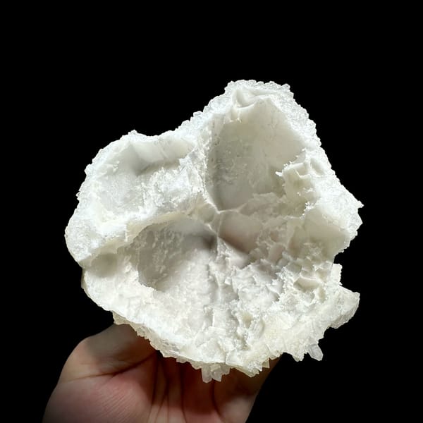Hollow-shell quartz cluster covered in white points from Fujian, China, top view