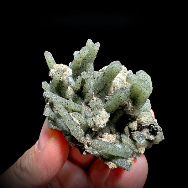 Green chlorite quartz prisms with white calcite from Inner Mongolia, China, held in hand