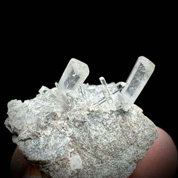 Long transparent aurora calcite prisms on grey rock from Zhejiang, China, second angle